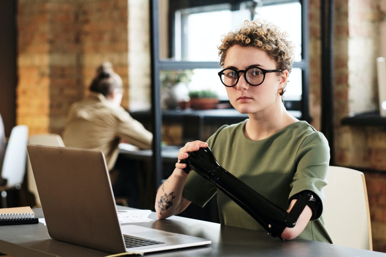 Woman sitting at her workplace with laptop
